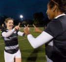 two soccer players point fingers at one another